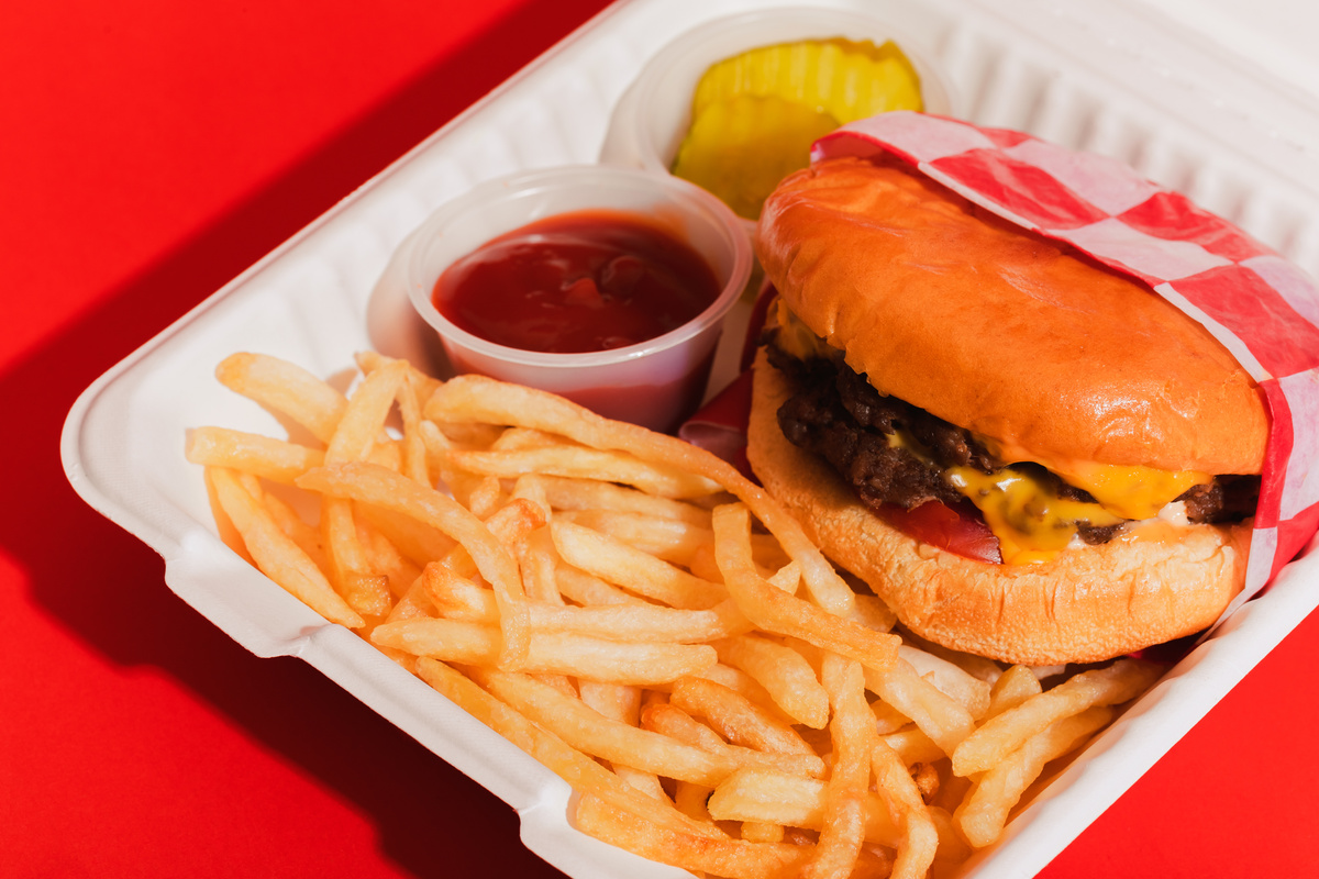 Conceptual Food Delivery Burger and Fries in Take Out Box